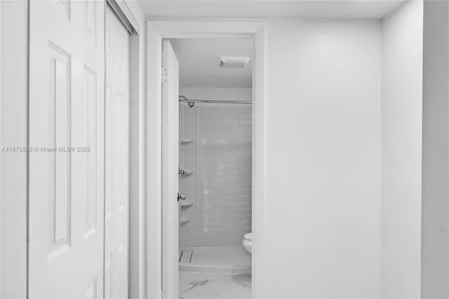 a bathroom with a shower and a toilet