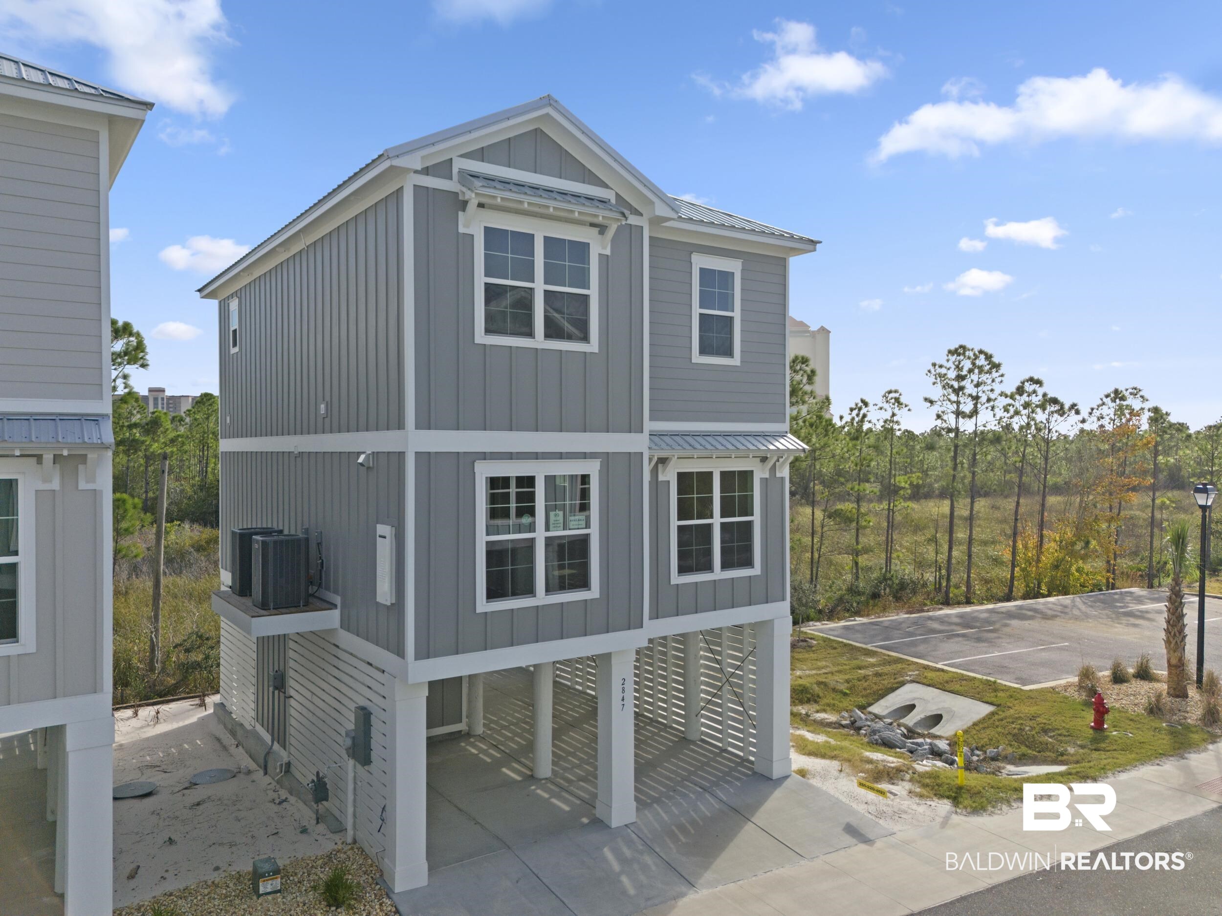 2847 Salt Drive Orange Beach, AL 36561 - Photo 3 of 29 View of side of property with central air condition unit and a carport