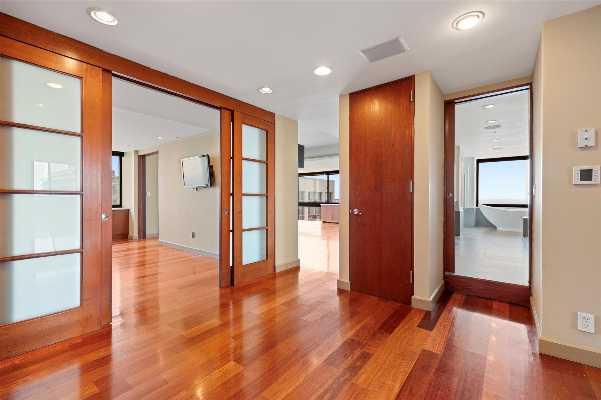 200 Old Palisade Road, Unit PH 4/5 Fort Lee, NJ 07024 - Photo 17 of 46 a view of a hallway with wooden floor and a cabinet