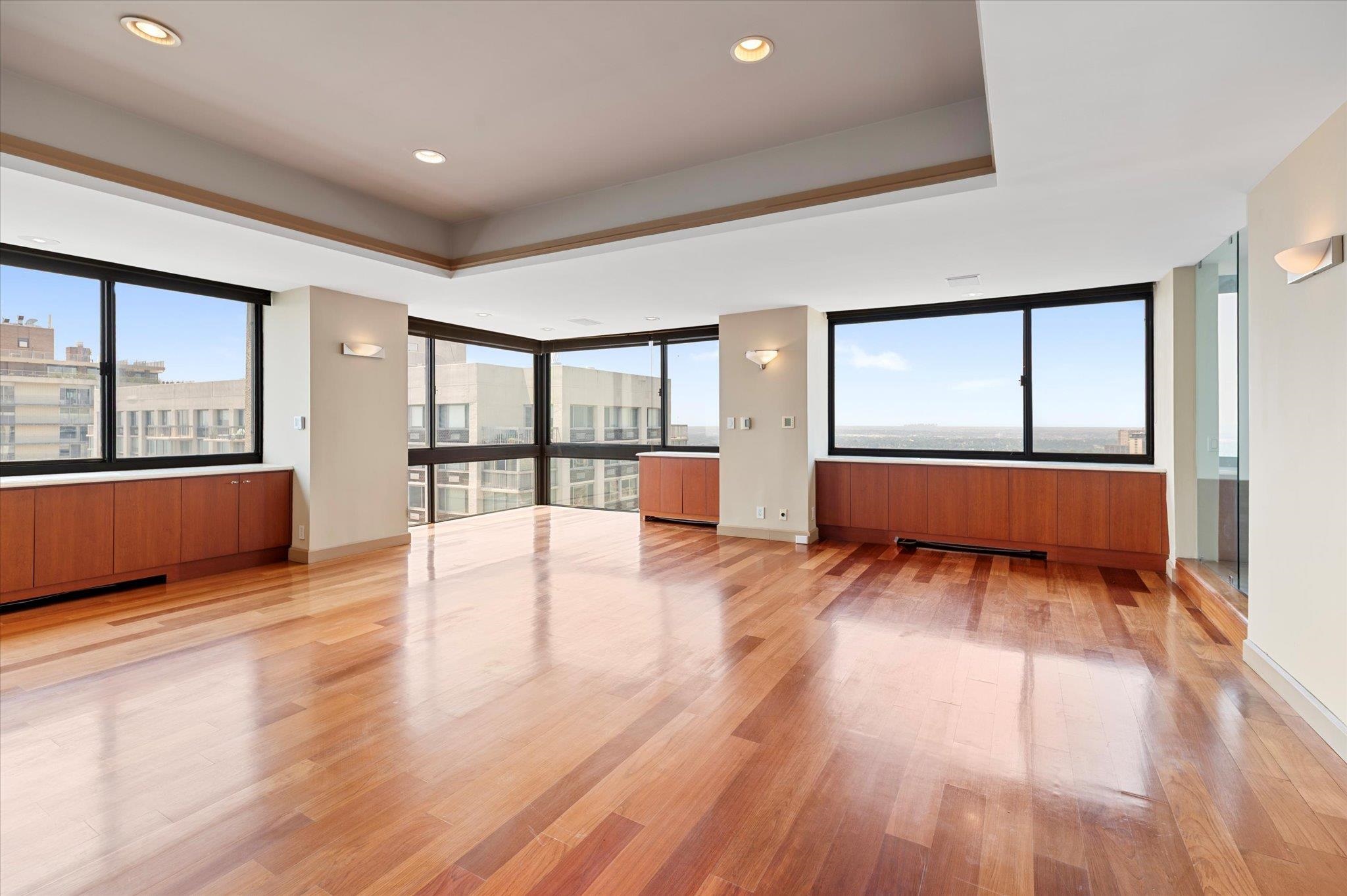 200 Old Palisade Road, Unit PH 4/5 Fort Lee, NJ 07024 - Photo 23 of 46 an empty room with wooden floor and windows