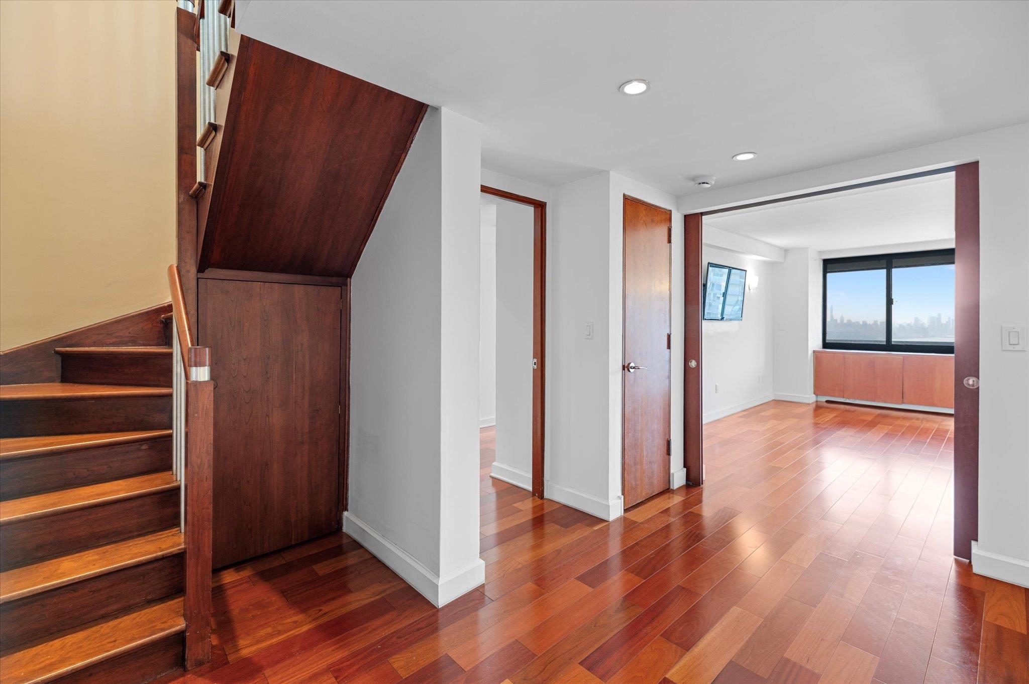 200 Old Palisade Road, Unit PH 4/5 Fort Lee, NJ 07024 - Photo 28 of 46 a view of hallway with wooden floor and stairs