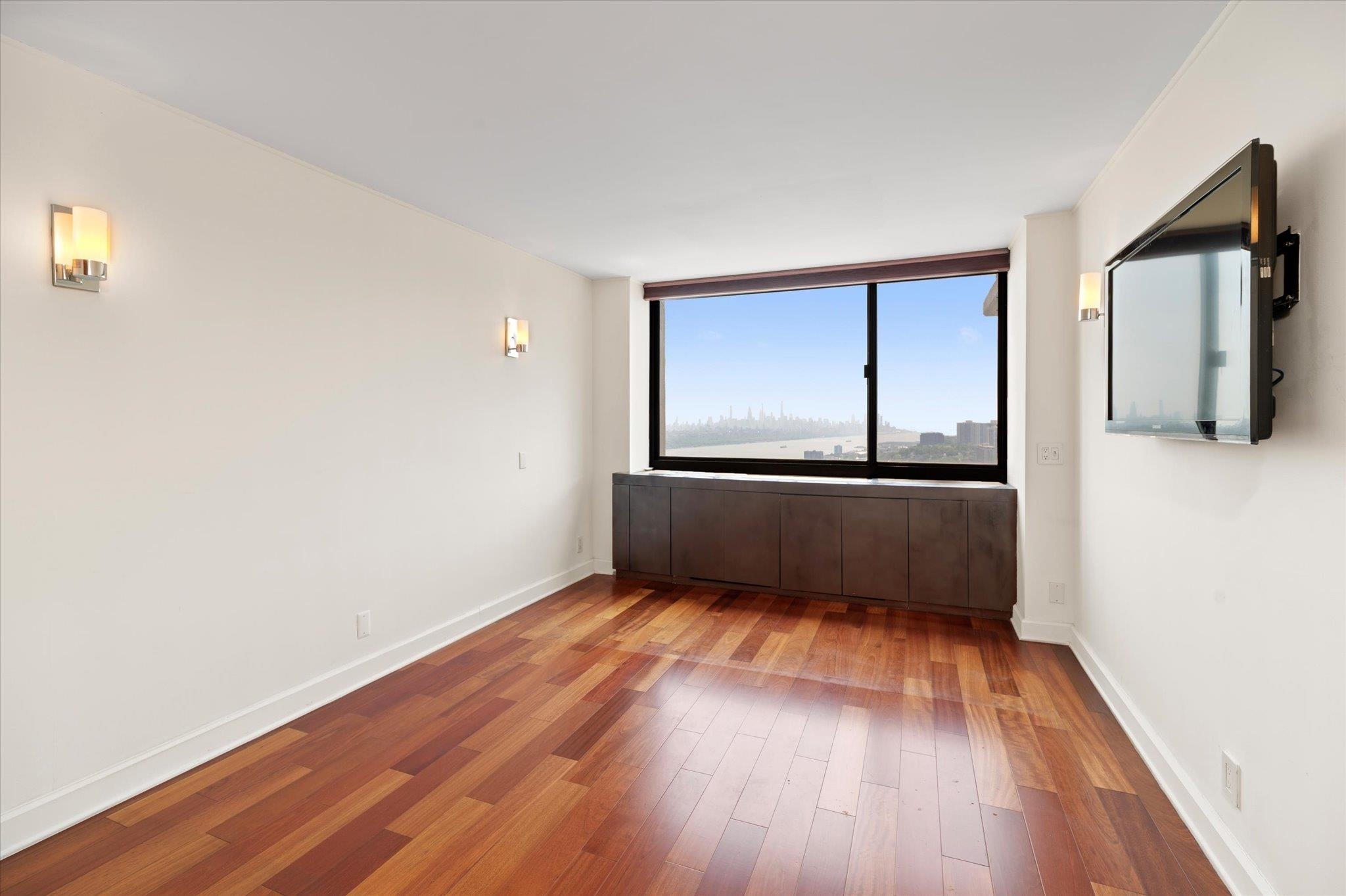 200 Old Palisade Road, Unit PH 4/5 Fort Lee, NJ 07024 - Photo 29 of 46 a view of a room with wooden floors and cabinet