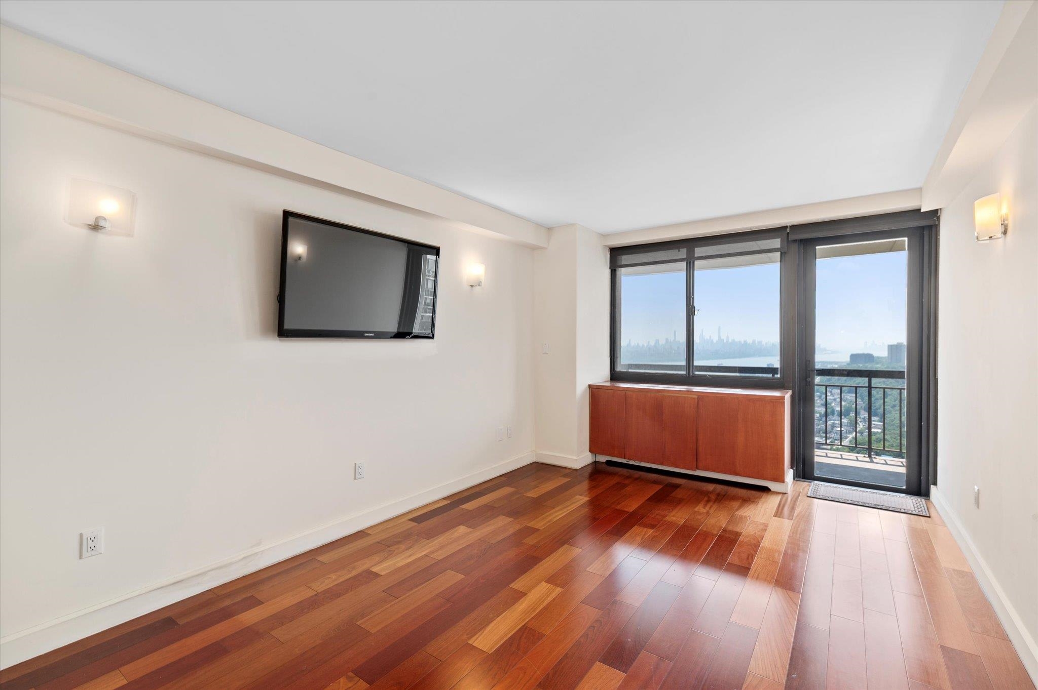 200 Old Palisade Road, Unit PH 4/5 Fort Lee, NJ 07024 - Photo 31 of 46 a view of an empty room with wooden floor and a window