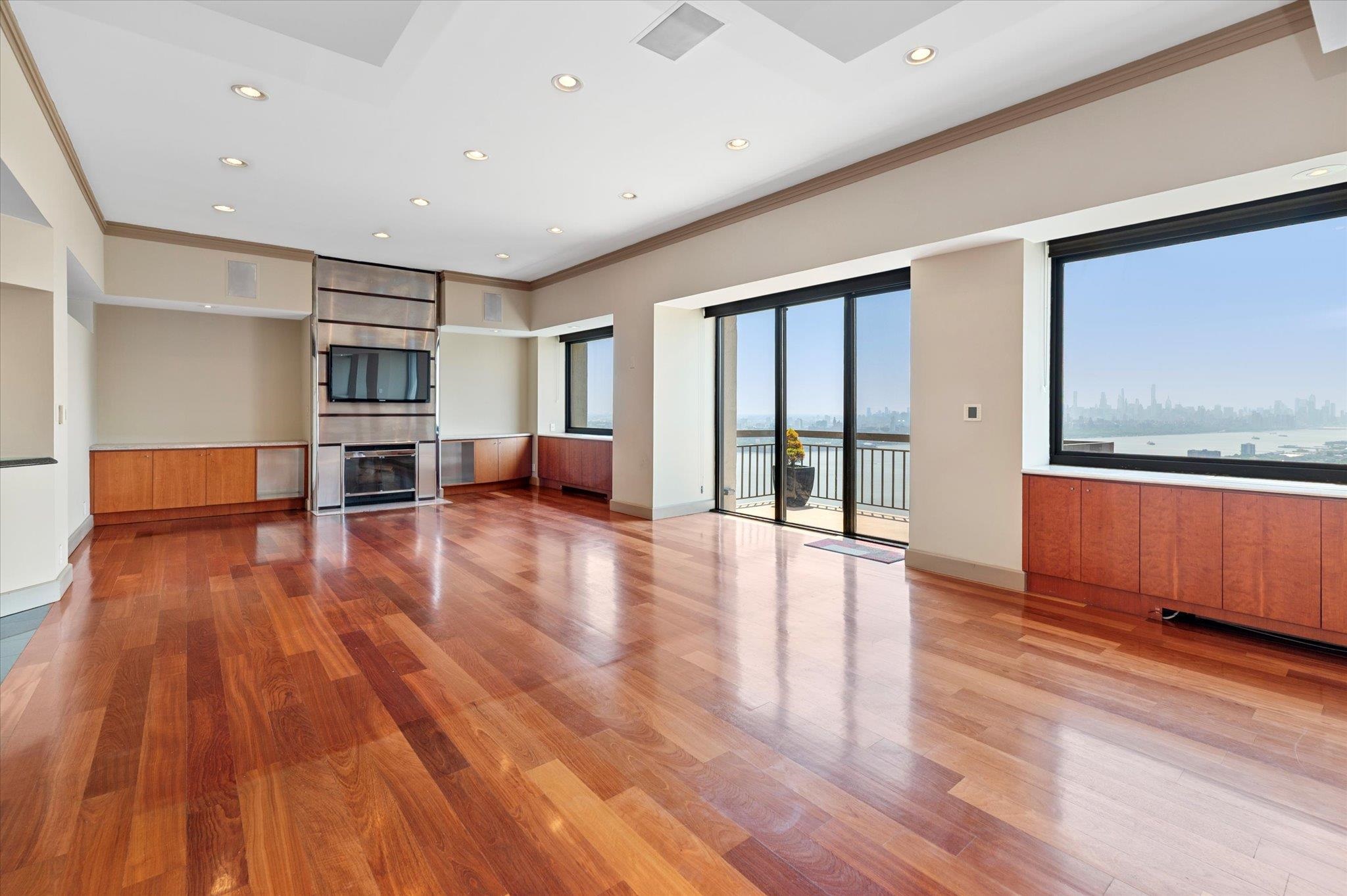 200 Old Palisade Road, Unit PH 4/5 Fort Lee, NJ 07024 - Photo 8 of 46 a view of empty room with wooden floor and furniture