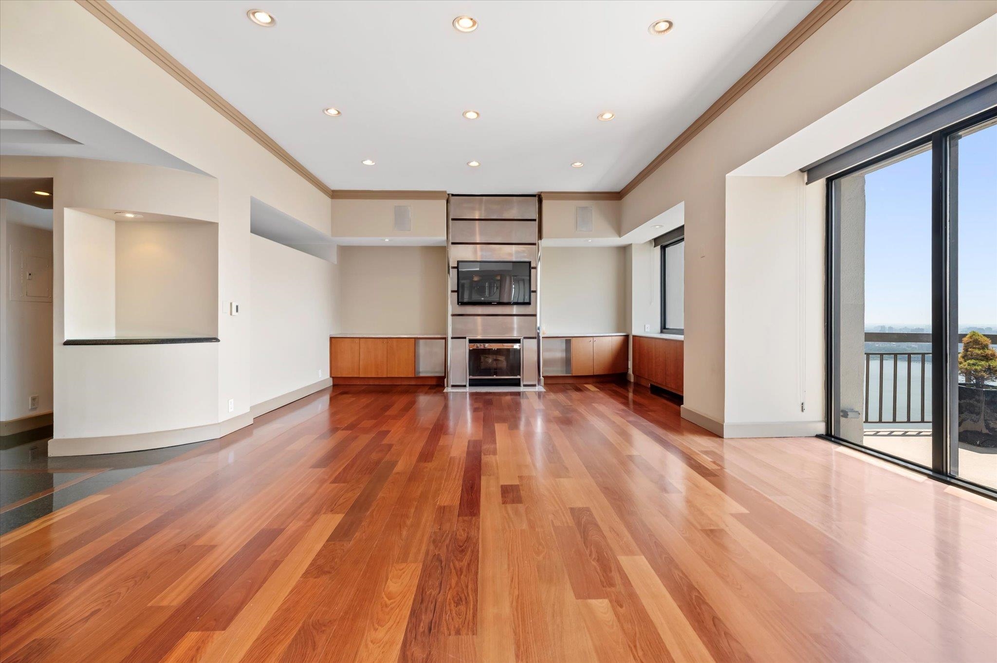 200 Old Palisade Road, Unit PH 4/5 Fort Lee, NJ 07024 - Photo 9 of 46 a view of empty room with wooden floor and windows