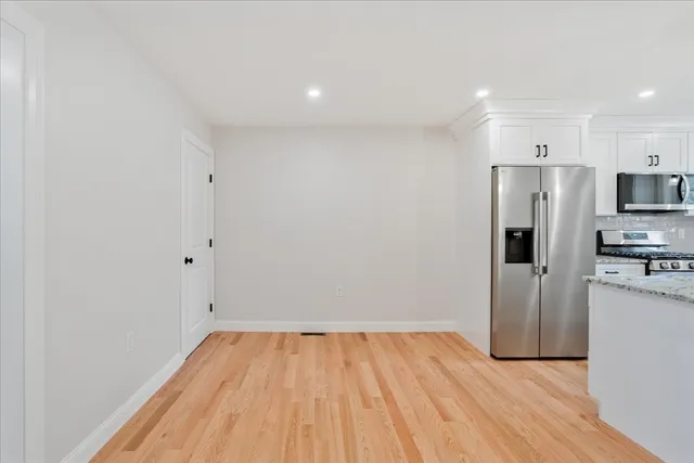 a view of a kitchen with a sink and a refrigerator