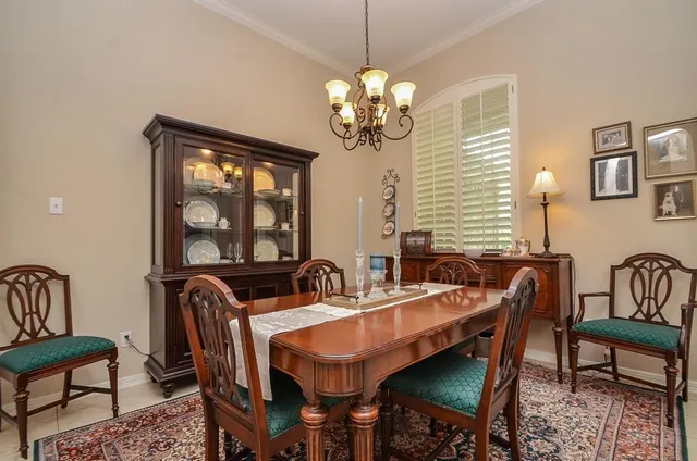 a dining room with furniture a chandelier and window