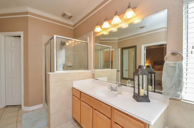 a bathroom with a sink vanity granite and a mirror