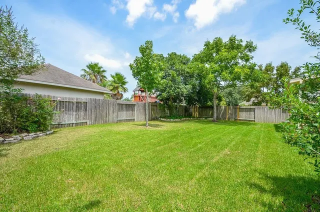 a view of a house with a backyard