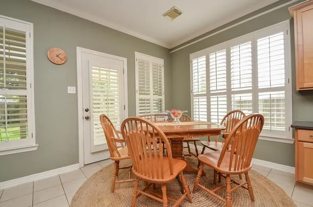 a view of a dining room with furniture and windows