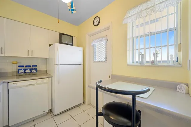 a kitchen with stainless steel appliances a refrigerator a sink and a stove