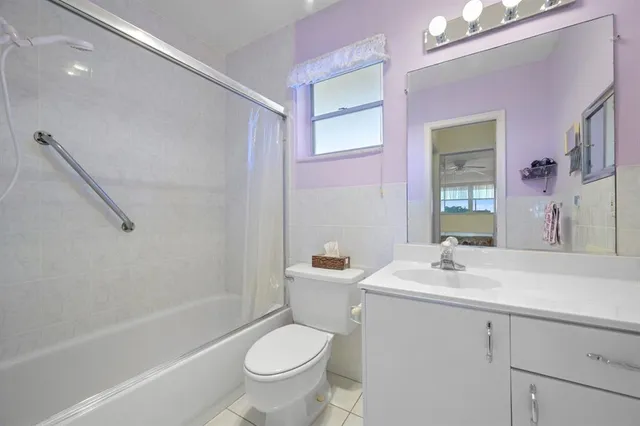 a bathroom with a sink toilet tub and shower