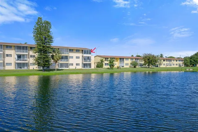 a view of house with outdoor space and lake