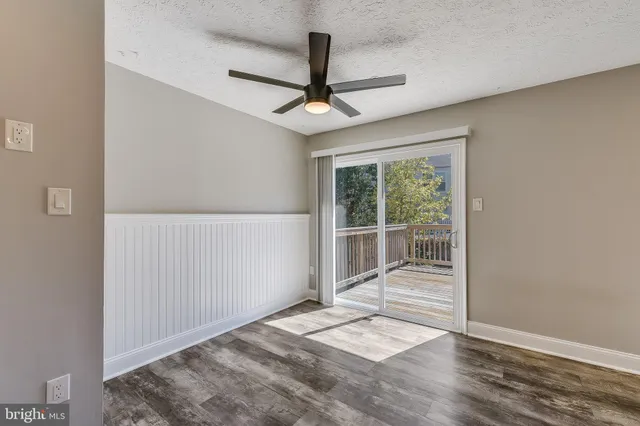 a view of a livingroom with a ceiling fan and window