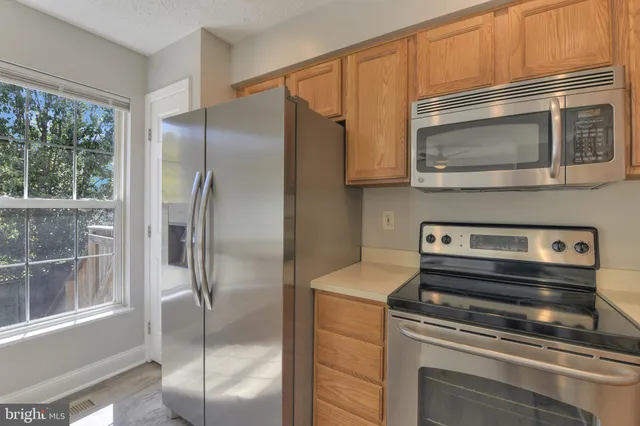 a kitchen with a refrigerator stove and cabinets