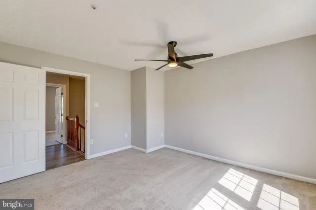 a view of a room with a ceiling fan