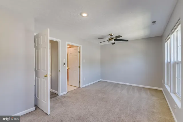 a view of a livingroom with a ceiling fan and window