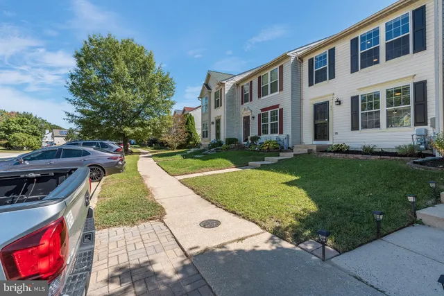 a backyard of a house with lots of green space and plants