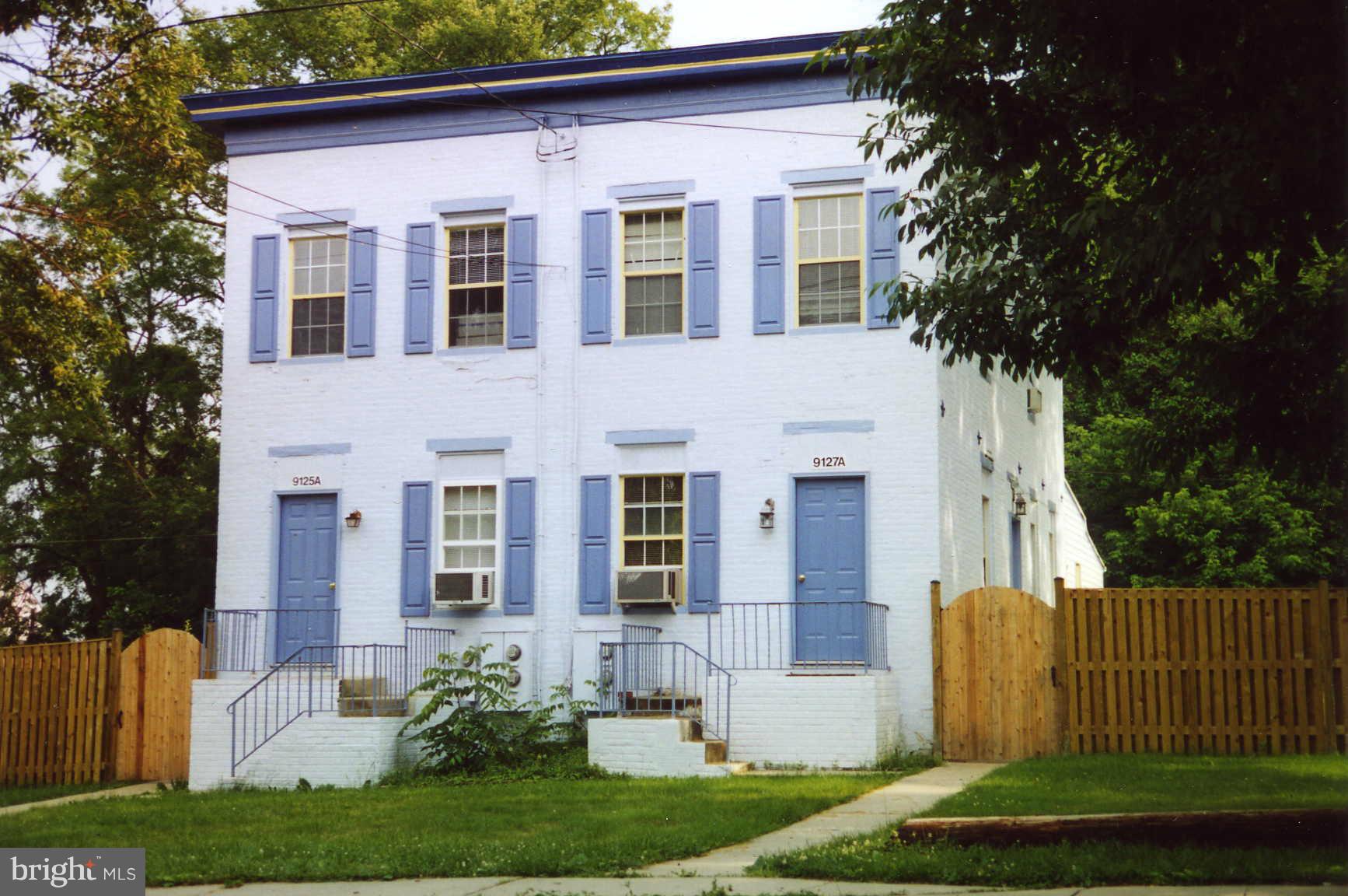 a front view of a house with a yard and a porch