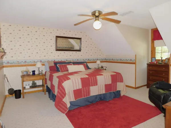 a bedroom with a bed and dresser