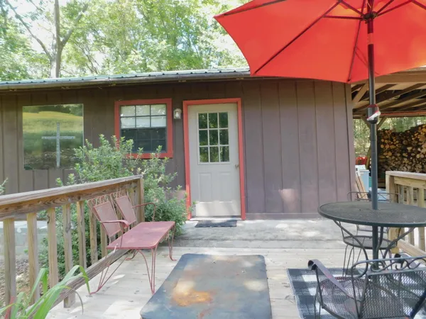 a front view of a house with outdoor seating