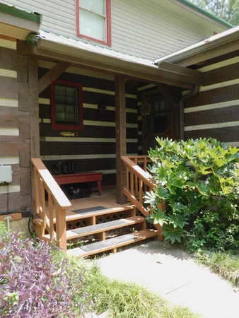 a backyard of a house with lots of green space and glass windows