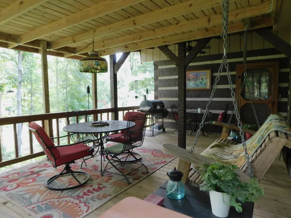 a view of a chairs and table in the patio