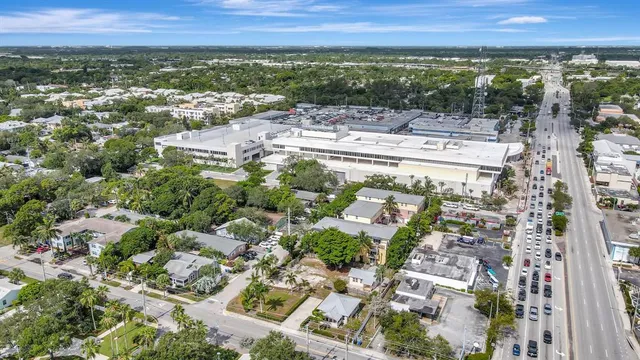 an aerial view of residential houses with outdoor space and trees