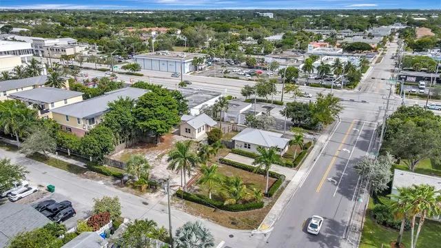 an aerial view of residential houses with outdoor space and street view