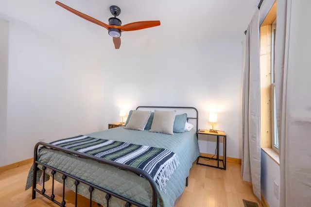 a bedroom with a bed and a window