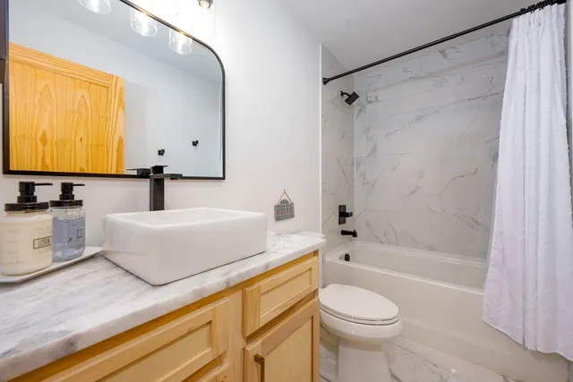 a bathroom with a sink a toilet and a bathtub