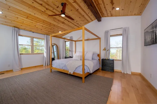 a spacious bedroom with a large bed and a window