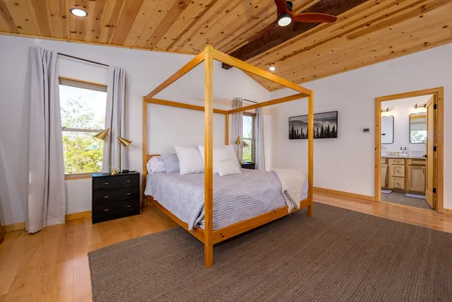 a bedroom with a bed and wooden floor