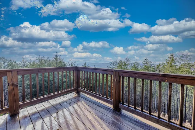 a balcony with wooden floor in city