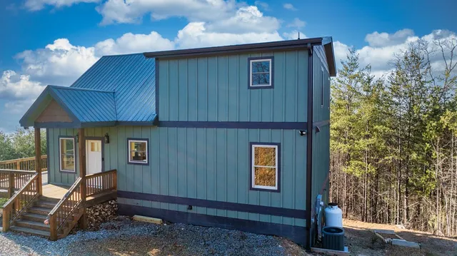 a view of backyard of house and wooden floor