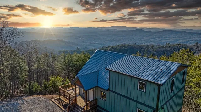 a backyard of a house with large trees and wooden fence