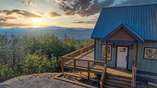 a view of a house with wooden fence and floor