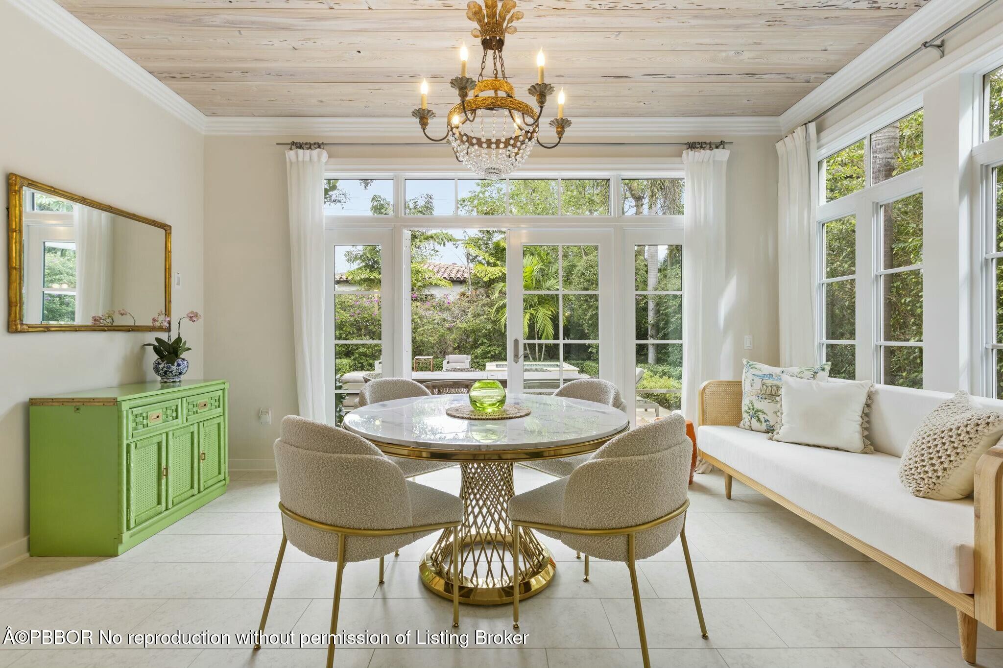 281 Cordova Road West Palm Beach, FL 33401 - Photo 11 of 25 a view of a dining room with furniture a chandelier and large windows