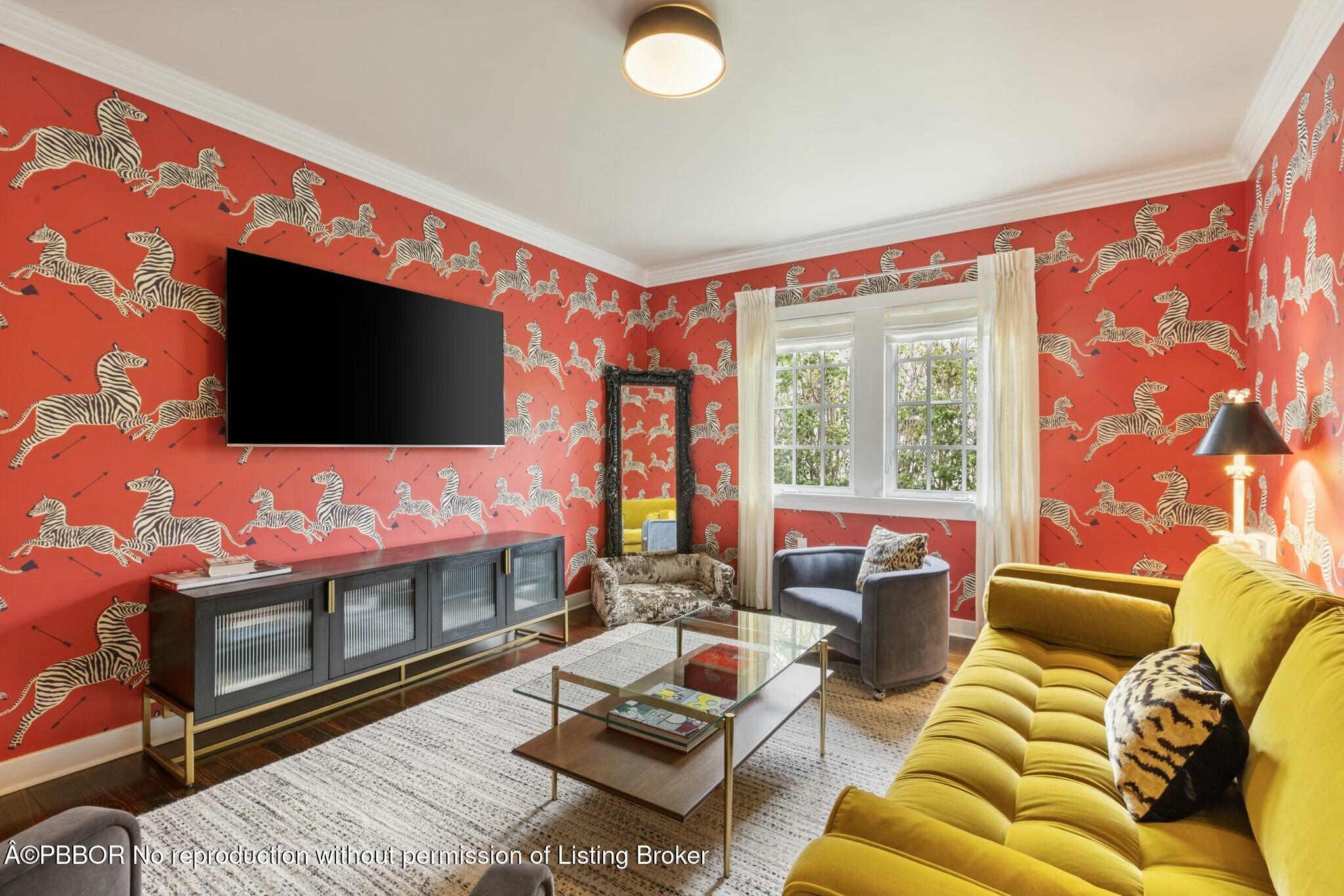 281 Cordova Road West Palm Beach, FL 33401 - Photo 19 of 25 a living room with furniture a flat screen tv and a floor to ceiling window