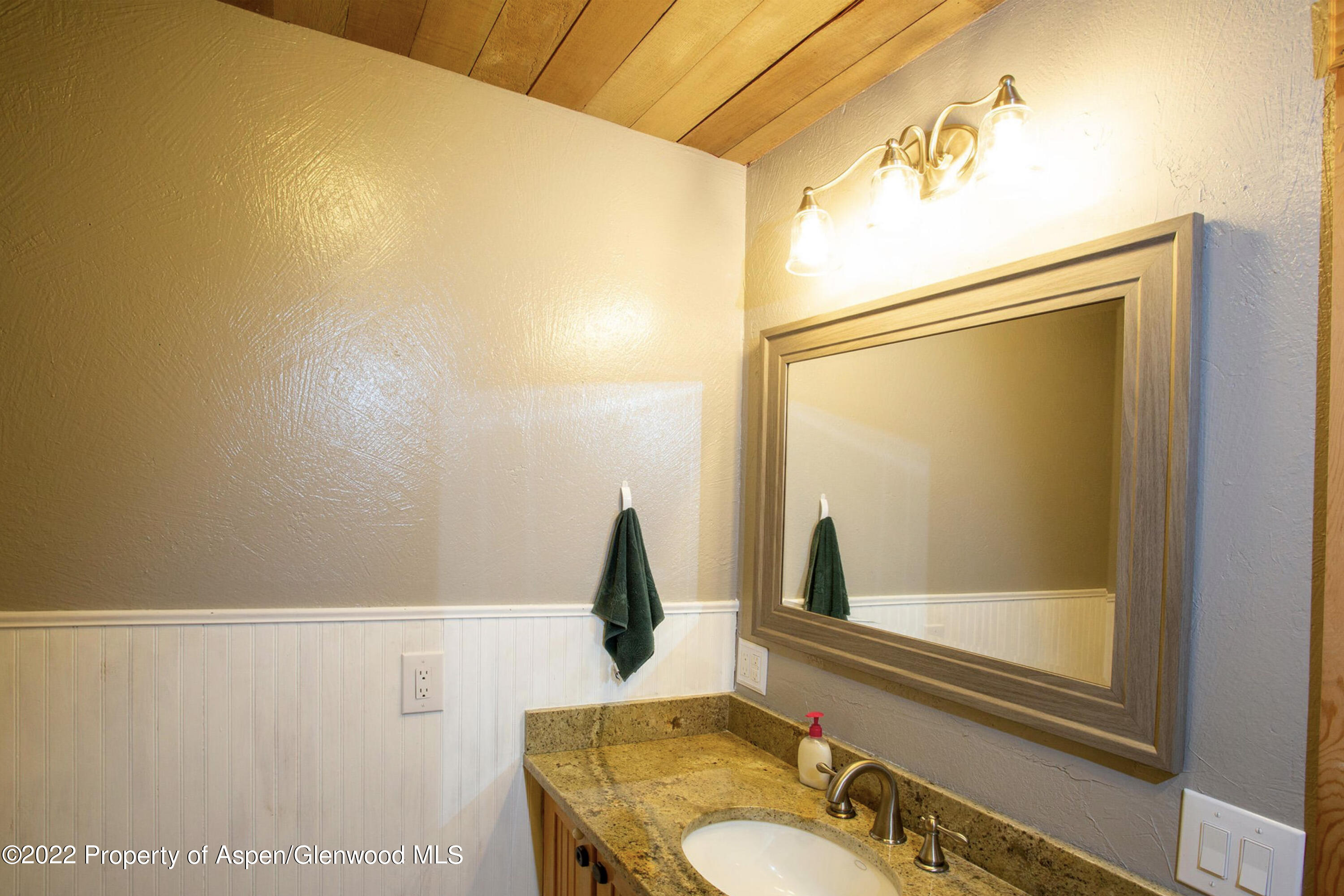 1407 County Road 237 Silt, CO 81652 - Photo 18 of 32 a bathroom with a granite countertop sink and a mirror