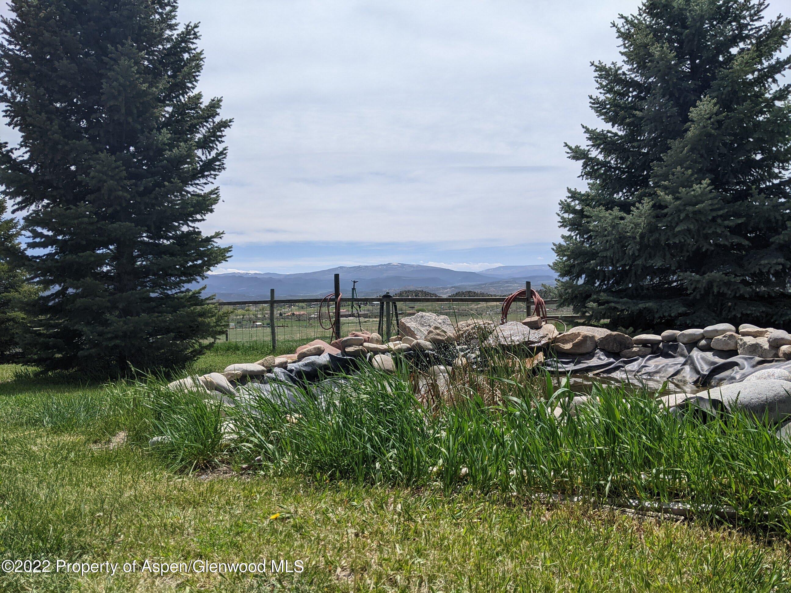 1407 County Road 237 Silt, CO 81652 - Photo 22 of 32 a view of a backyard with plants and a bench