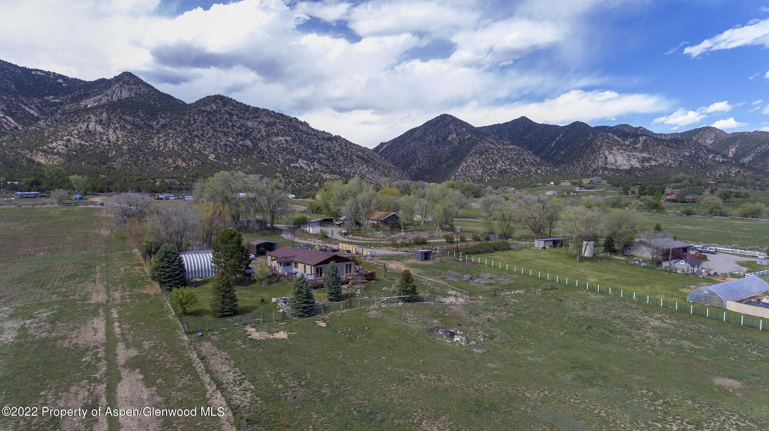 1407 County Road 237 Silt, CO 81652 - Photo 3 of 32 a view of a lush green hillside and houses