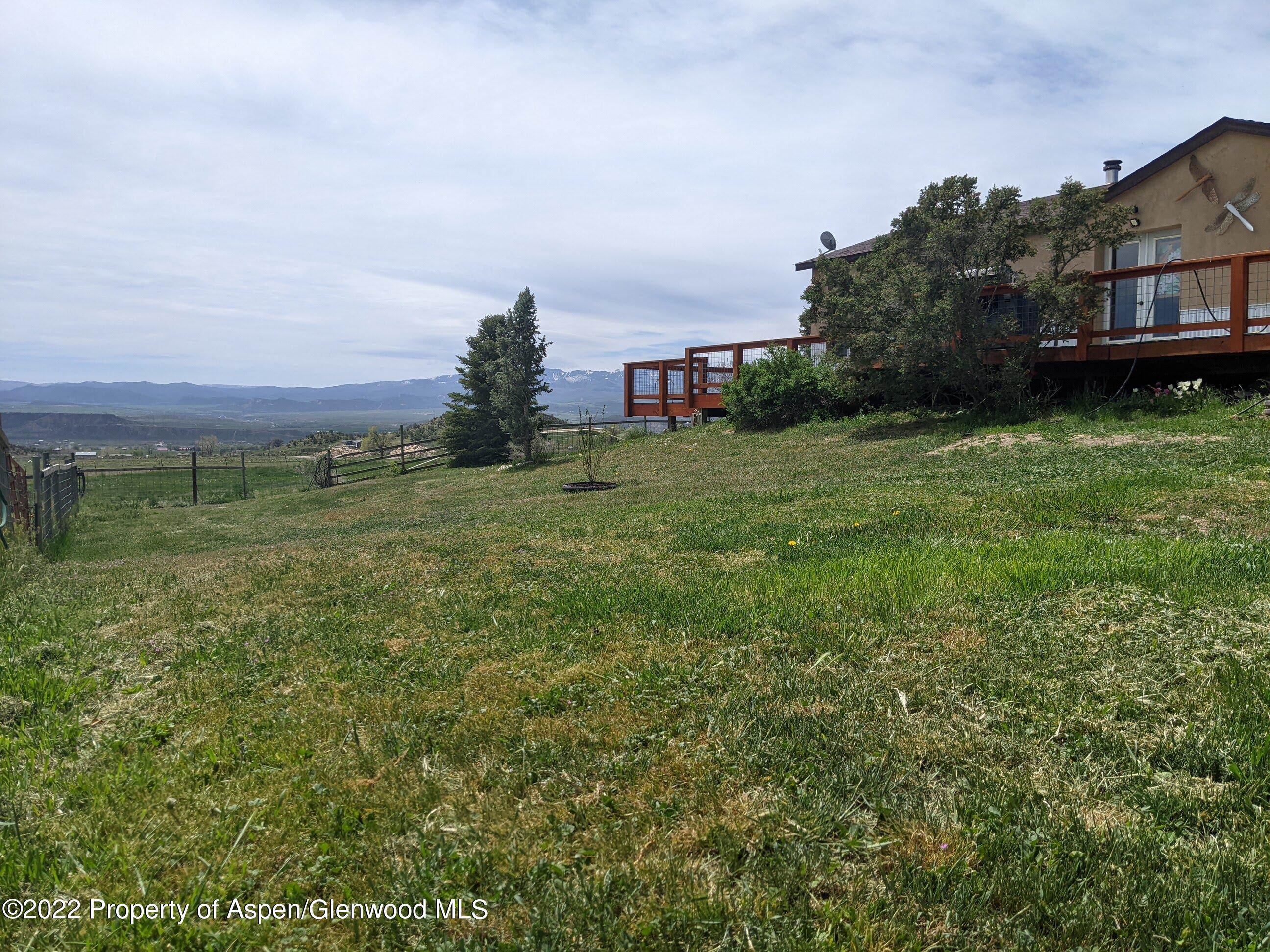 1407 County Road 237 Silt, CO 81652 - Photo 31 of 32 a view of a big house with a big yard and large trees