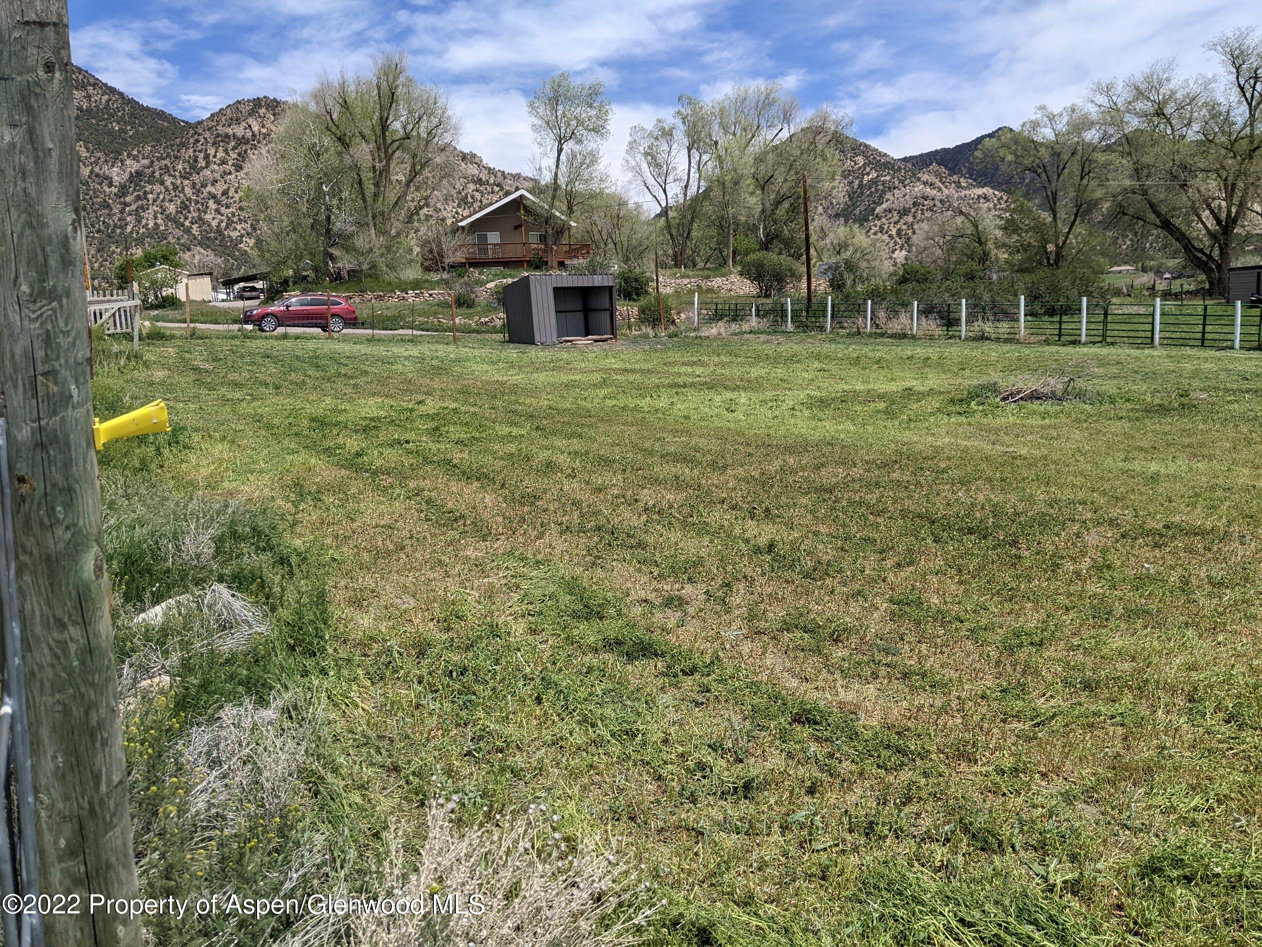 1407 County Road 237 Silt, CO 81652 - Photo 32 of 32 a view of a house with a big yard and large trees
