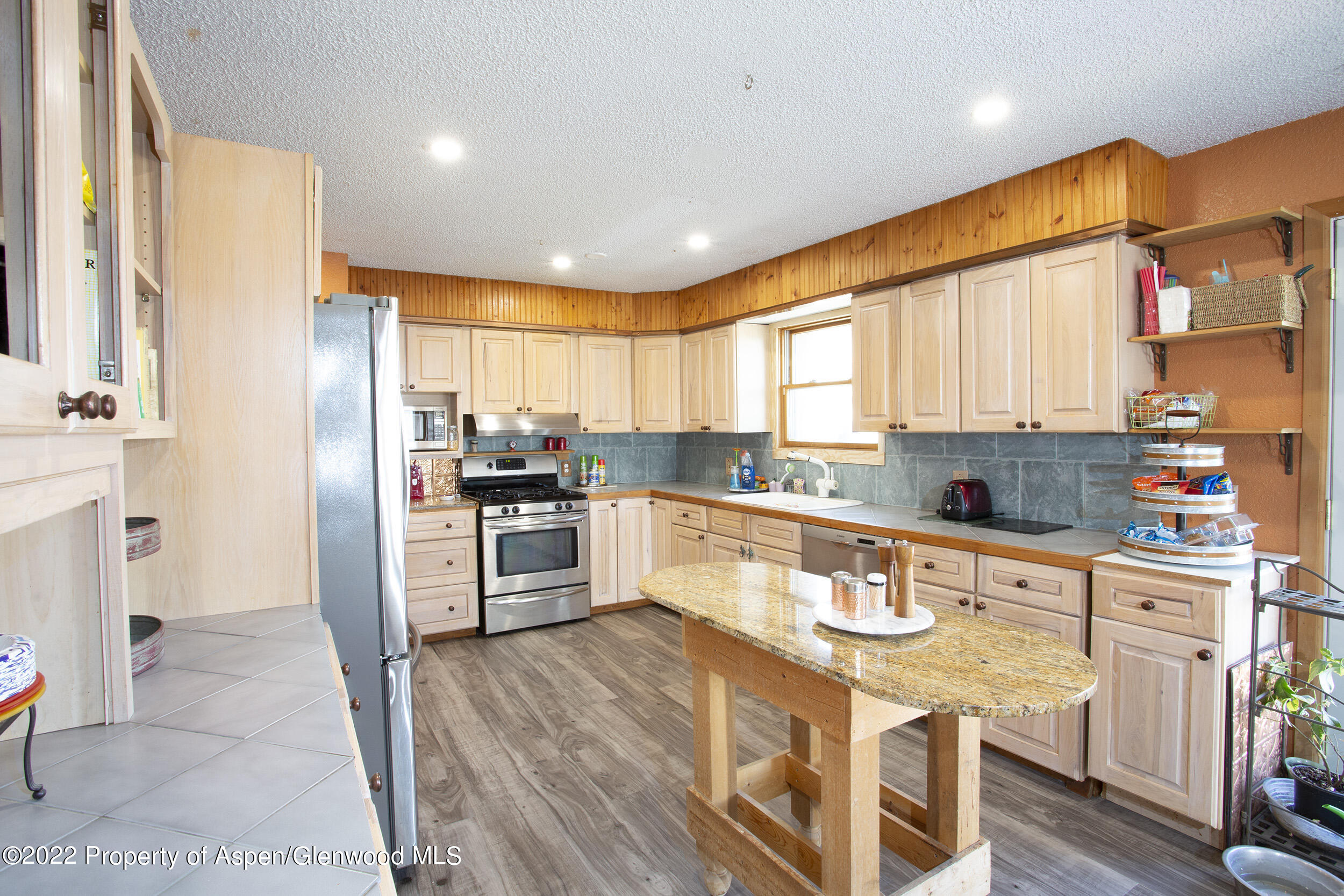 1407 County Road 237 Silt, CO 81652 - Photo 4 of 32 a large kitchen with stainless steel appliances granite countertop a refrigerator and a stove top oven