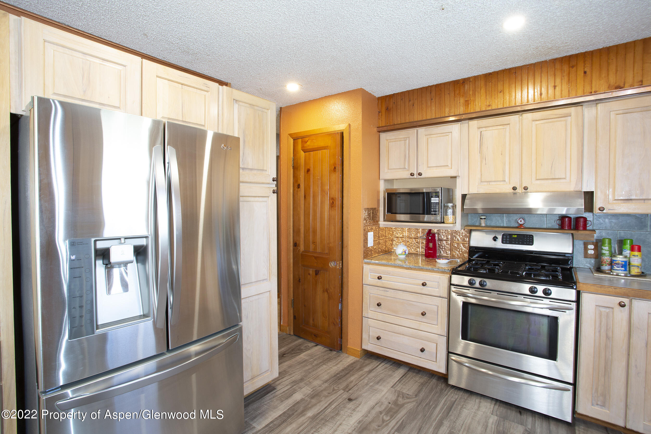 1407 County Road 237 Silt, CO 81652 - Photo 8 of 32 a kitchen with stainless steel appliances a refrigerator stove and cabinets