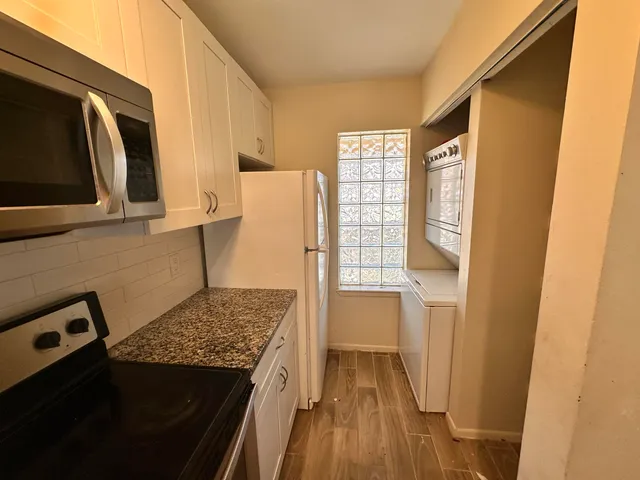 a kitchen with a refrigerator and a stove