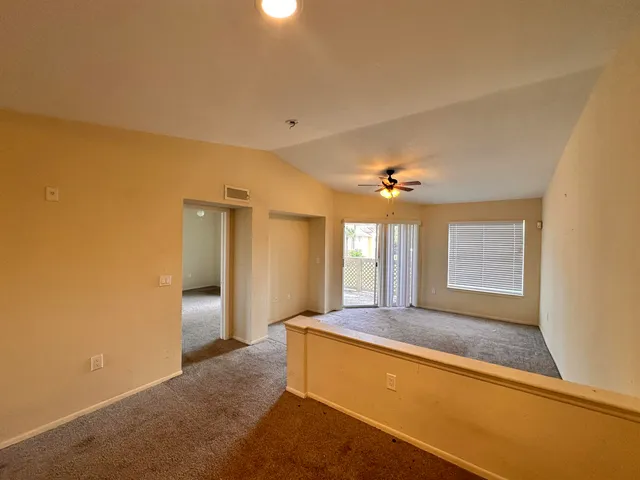 a spacious bathroom with a granite countertop sink a mirror and a shower