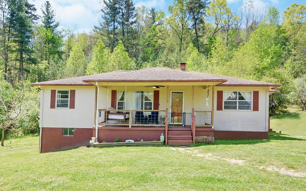 a view of a house with a yard porch and sitting area