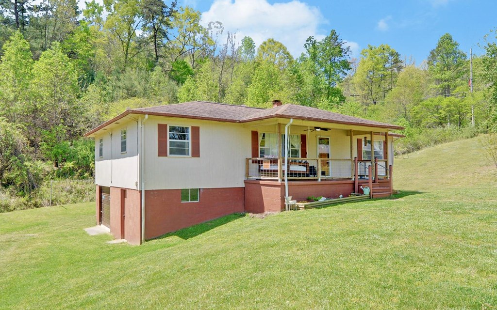 810 Grassy Creek Road Copperhill, TN 37317 - Photo 33 of 33 a view of a house with a yard porch and sitting area